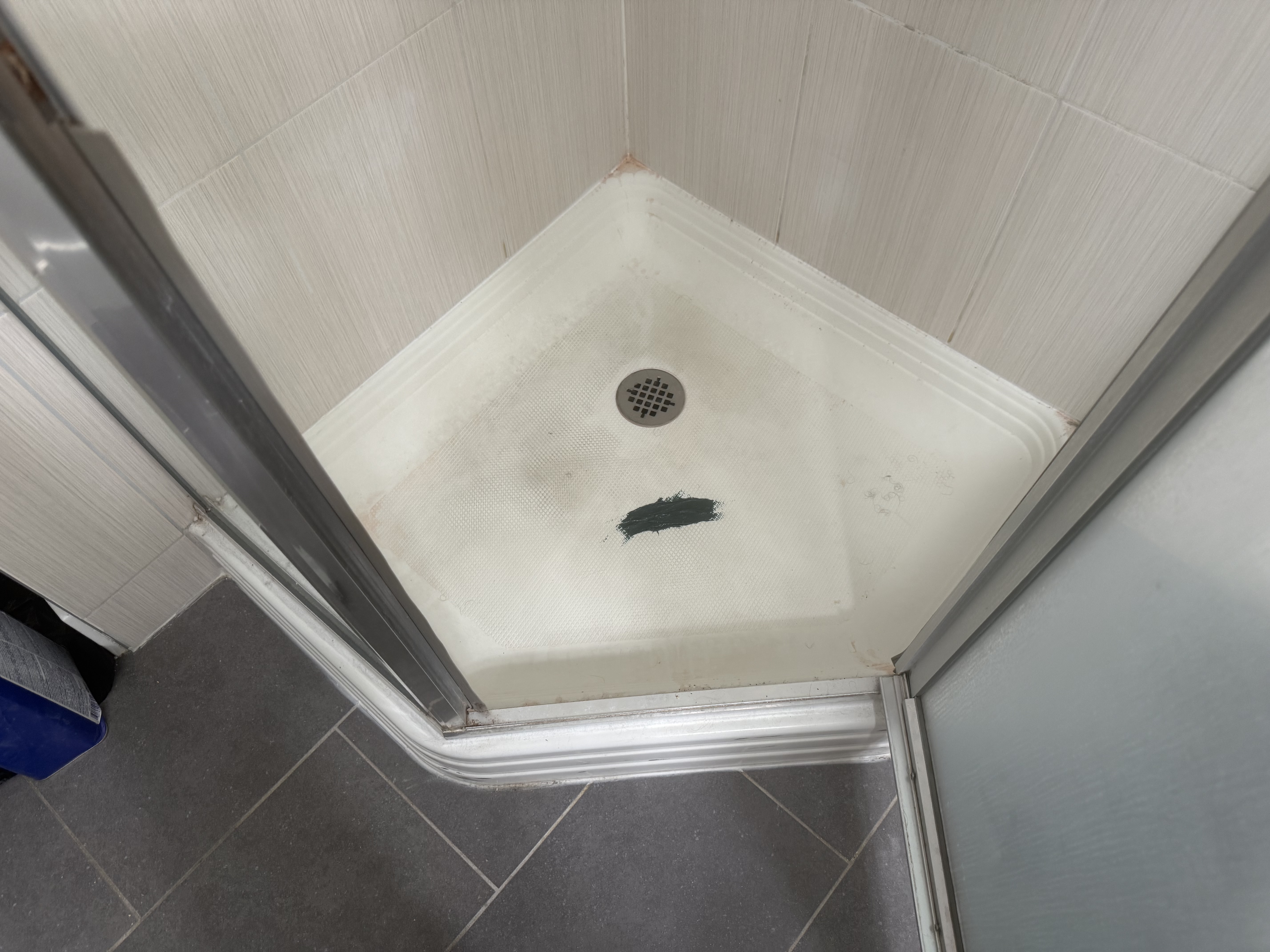 Before shower pan refinishing - stained and damaged shower base