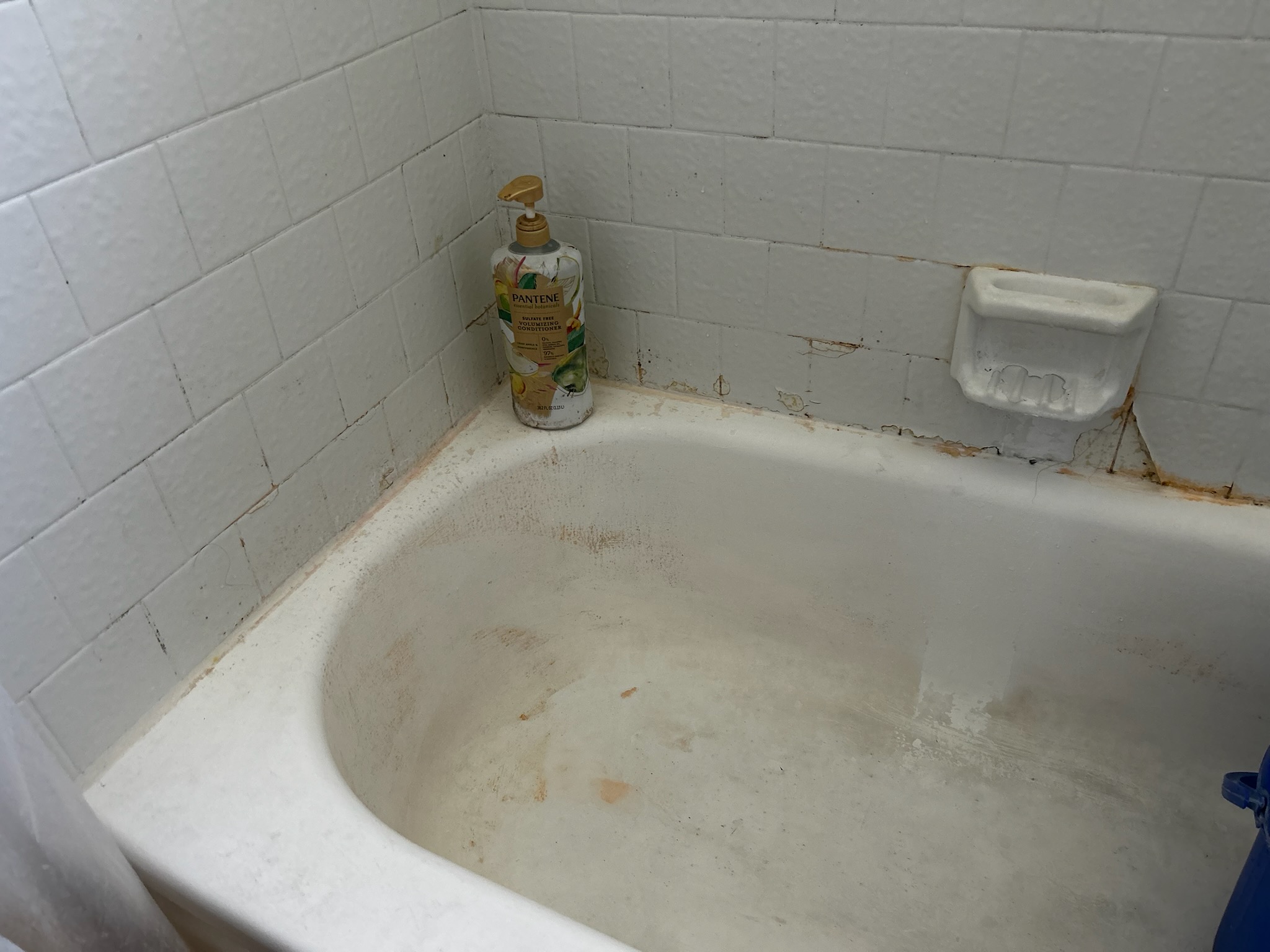 Worn bathroom tile with chips and damaged finish - tile resurfacing repairs damage