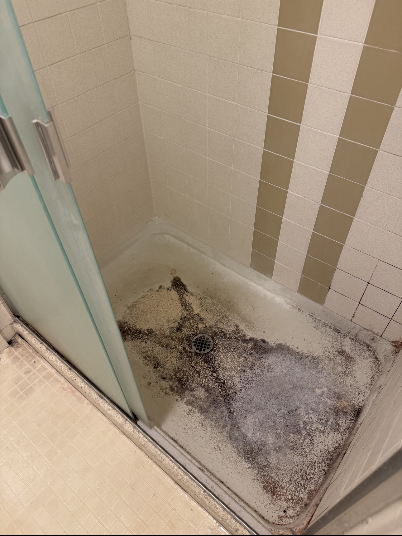 Cracked fiberglass tub shower unit before refinishing