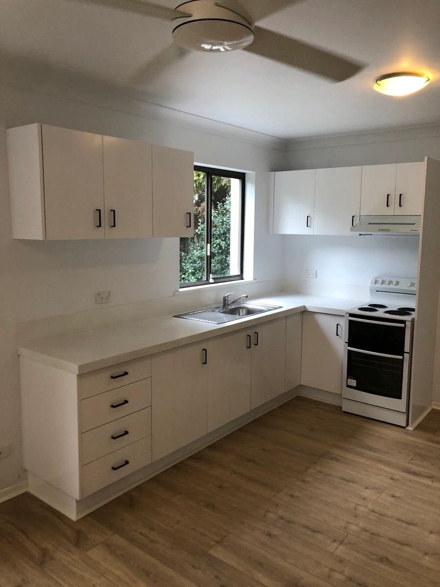 The same kitchen after its cabinets were sprayed white