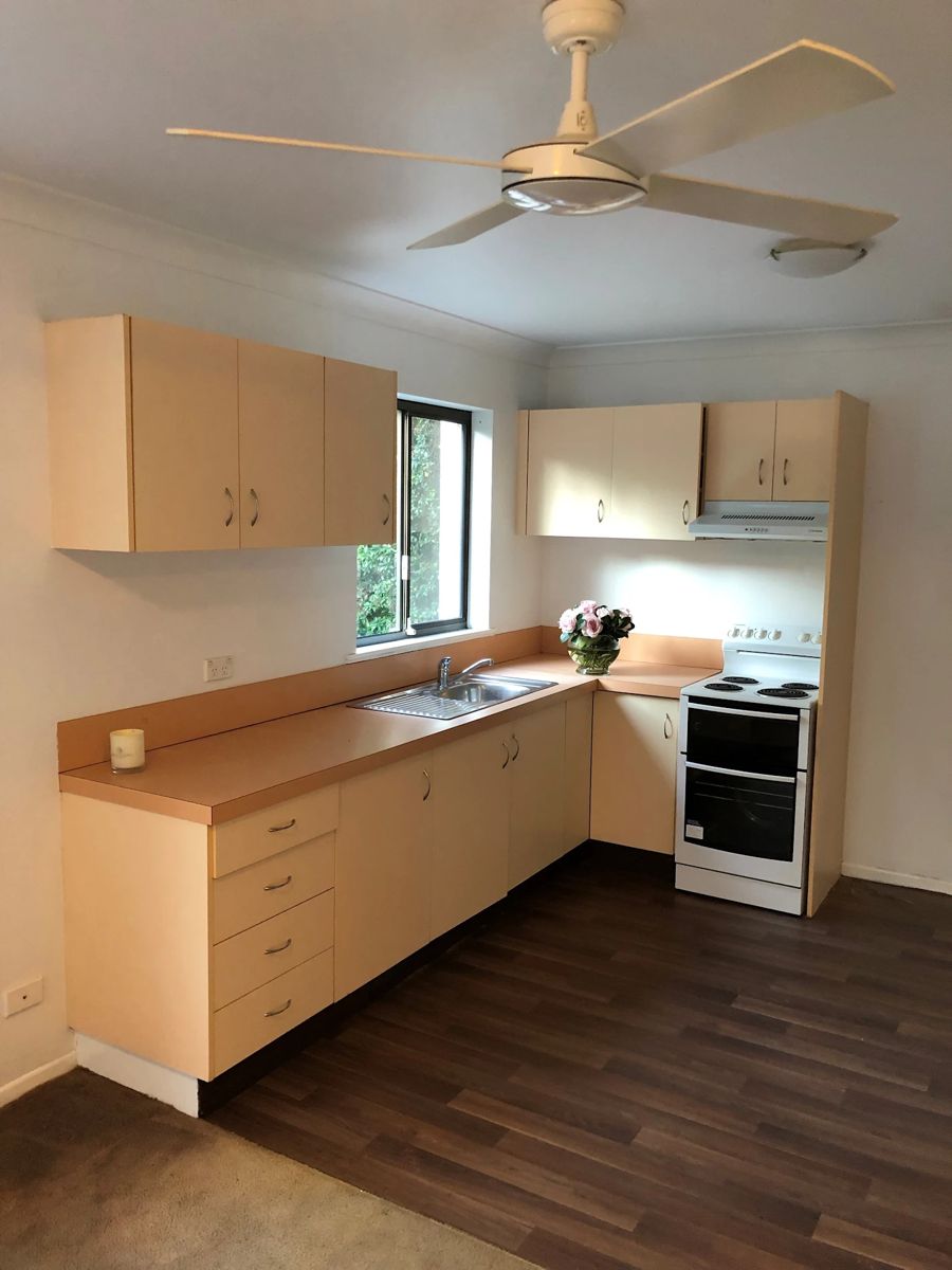 Kitchen with cream laminate cabinets before painting