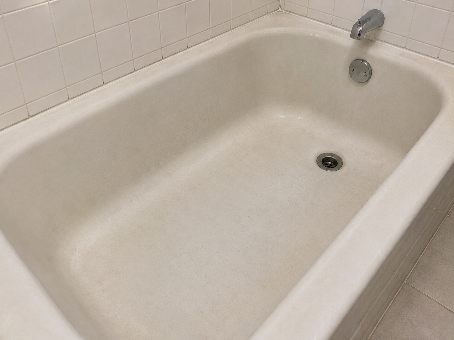 Dull bathtub before restoration - faded finish with no shine