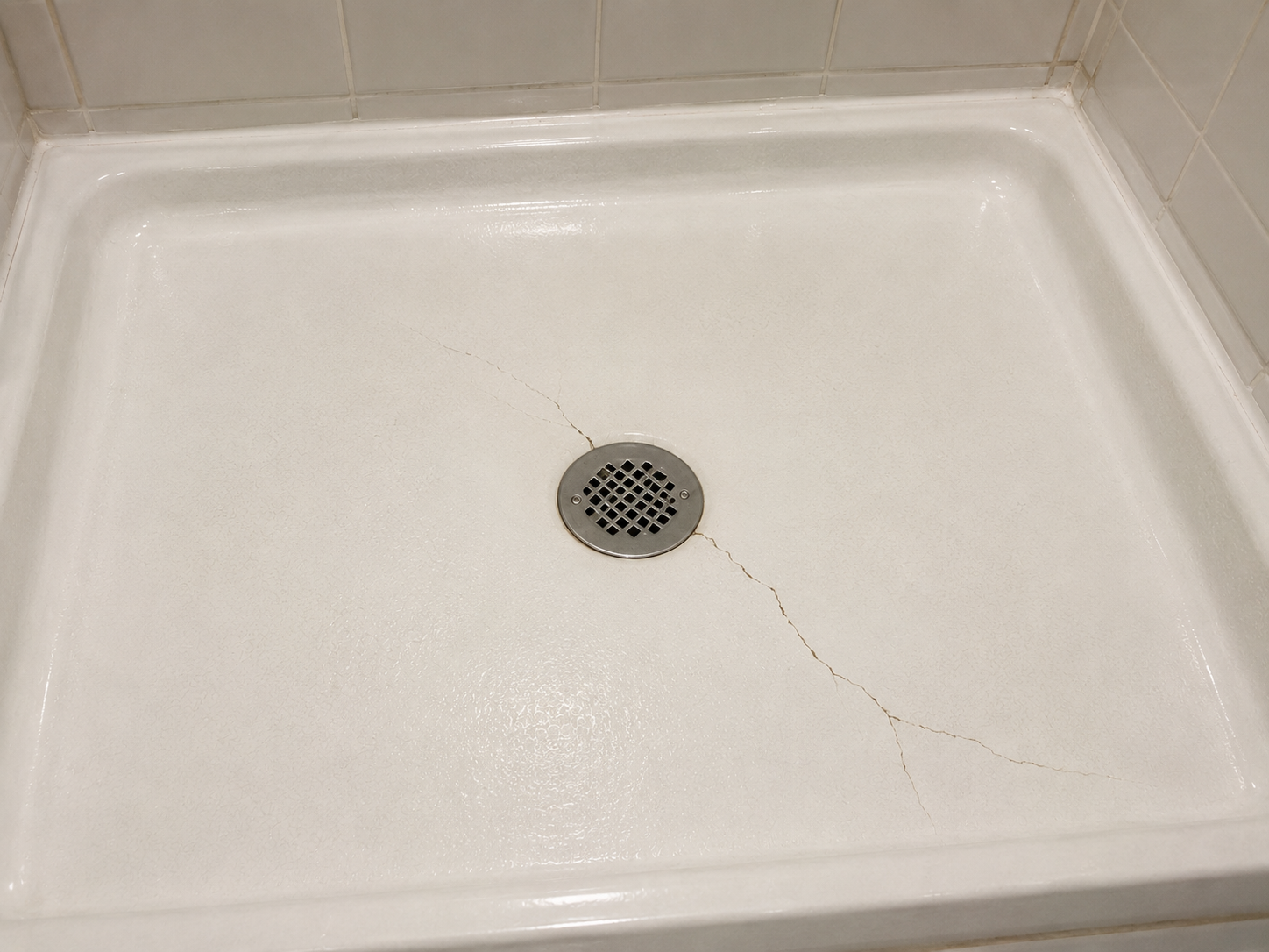 Cracked shower pan before repair